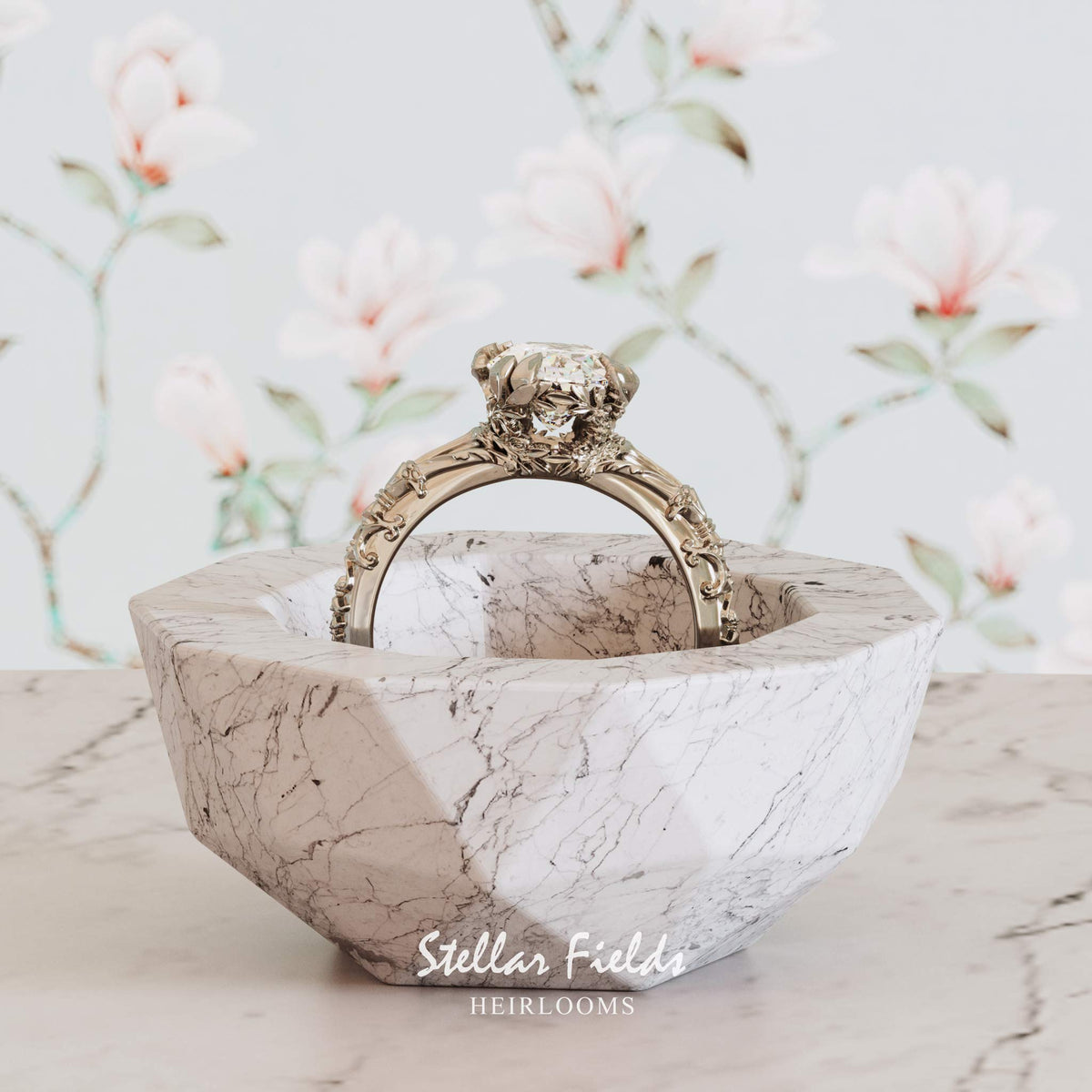 An ornate, nature inspired platinum ring with a oval cut diamond
