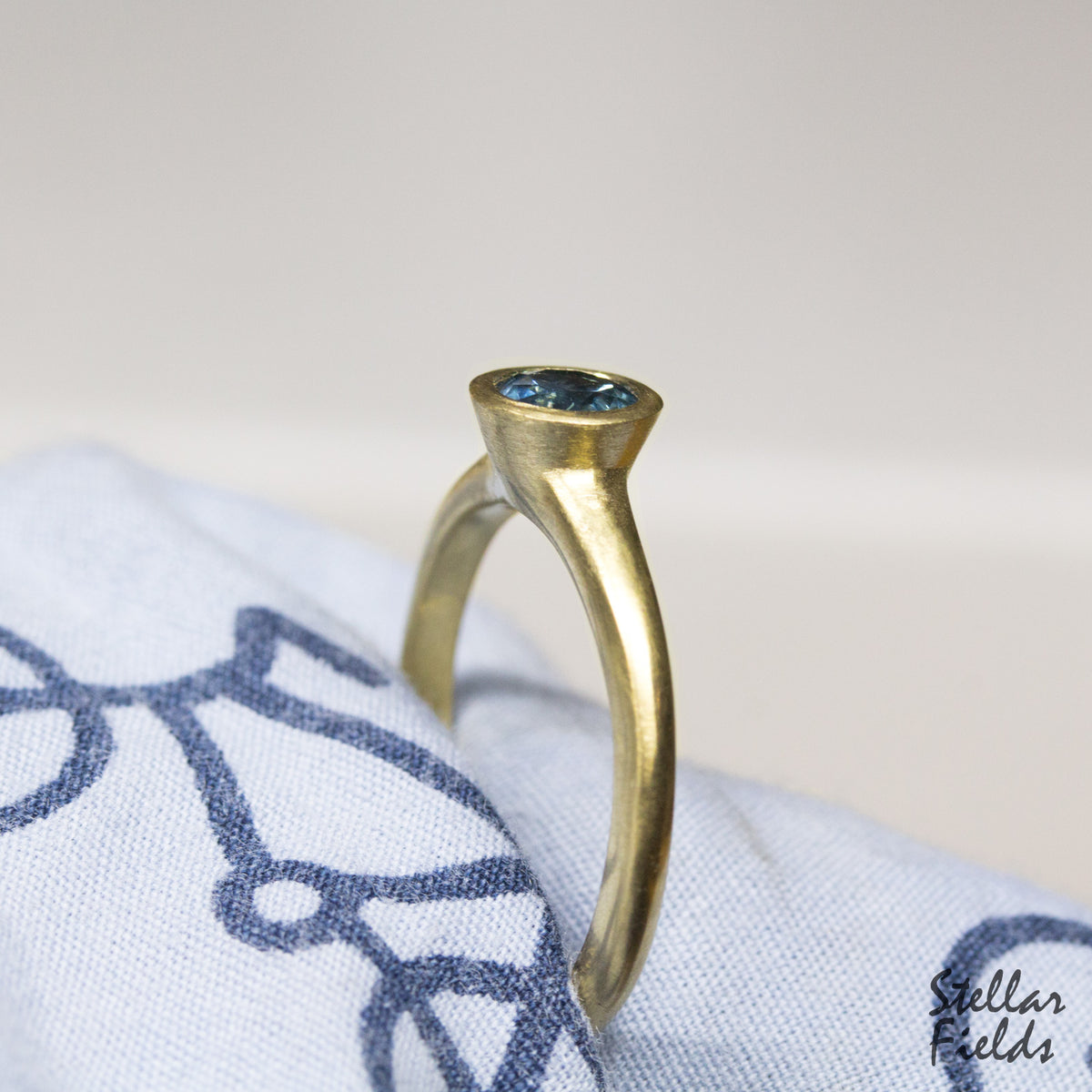 modern bezel engagement ring blue sapphire 14k yellow gold Stellar Fields Jewelry